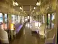 Interior view of E127-100 series set showing mixed longitudinal/transverse seating and driver-only-operation ticket issuing machine