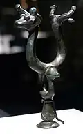 Bronze part of a yoke with bull heads and birds