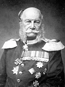 Black-and-white photograph of an elderly Wilhelm, a bald man with side whiskers