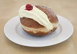 Kitchener bun with cream on a plate