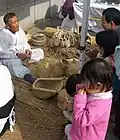 A man (left) making chipsin (2008)