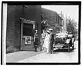 Another angle of Throckmorton, Mullin, Hogan and others with a Chevrolet Model D V8