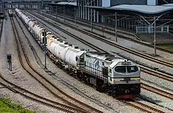 A KTMB Class 26 is resting with its cement train at Ipoh station.