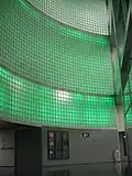 The backlit mural from the pre-platform level