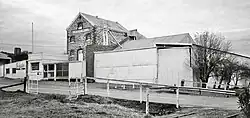 Photo of stone and corrugated steel flour mill with railway siding nearby