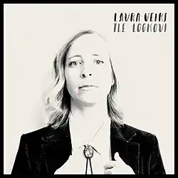 A black-and-white photo of Veirs' face