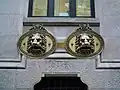 Lion heads on the windows of the mailboxes in García Camba Street