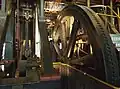 Flywheel and a vertical rod. A horizontal rod is on the left. A crank is between the two rods.