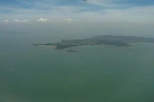 Fuxing Islet (islet near the center of photograph) off the coast of Lesser Kinmen (the larger island of Lieyu Township)