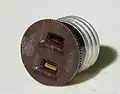 Converts a light bulb socket into an electrical receptacle