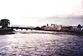 alt = a view of a road bridge with a castle on the right bank
