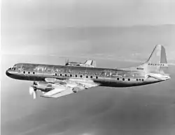 Image of an aircraft in level flight over a coastline
