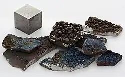A rough fragment of lustrous silvery manganese metal