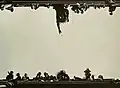 Artistic view of a Mardi Gras krewe member throwing a Mardi Gras Doubloon