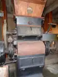 Roller mill produced by the C. Skoryna company, preserved in the mill in Niegów, with an enlargement of the nameplate