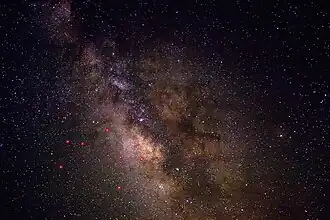A view of the night sky near Sagittarius, enhanced to show better contrast and detail in the dust lanes. The principal stars in Sagittarius are indicated in red.