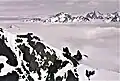 The two prominent peaks in the distance are Mts. Mystery and Deception. Hal Foss Peak can be seen between them. View is from Mt. Constance.