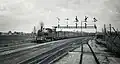 NS 6108 with an express train Enschede-Amsterdam near the signal gantry near Bussum. (Between 1925 and 1935)