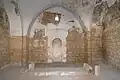 The interior of the shrine-mausoleum, the simple grave dedicated to Joshua is visible in front of the mihrab, painted in white