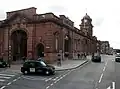 covered vehicle entry outside stone building