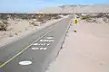 Road markings south of the dip with the vado to the north beyond on Fed.&nbsp;5.[clarification needed]