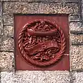 Terracotta panel with initials