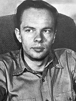A black-and-white photo of Dick seated