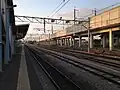 View from platform 4, showing the passing loop and sidings to the east (right) and the elevated Shinkansen tracks.