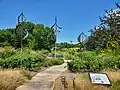 The Missouri Botanical Garden's Prairie Garden in 2023. It includes stone paths and metal animal silhouettes.