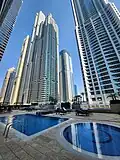 Outdoor pools and sunbathing area for residents