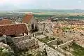 House ruins along the wall and town below