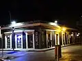 A bouncer stands guard outside a downtown Ponce lounge