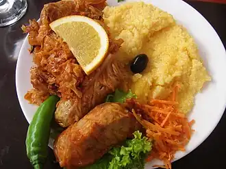 Image 1A popular Moldovan dish of Stuffed Cabbage Rolls (sarma), accompanied by sauerkraut and mămăligă. (from Culture of Moldova)