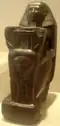 A kneeling statue of Senenmut, now in the Metropolitan Museum.