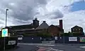North-east side of the mill in June 2013 showing the scaffolding with white plastic sheeting for the restoration. Taken from the junction of St Michael's Street and Sultan Road.