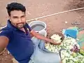 Slicing the peeled mangoes into long thin slices