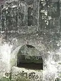 A niche for a statue, above the well