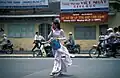 A female student wearing Áo dài