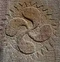 A lauburu on the baptismal font at the church of Knopp-Labach