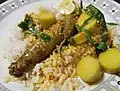 Roe and bamboo shoots masak lemak lada api served on a bed of cooked rice.