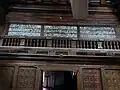 Inscription and wooden carving in panels
