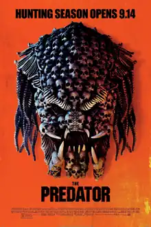 Infrared vision showing the Predator creature's head full of skulls and "THE PREDATOR" title on a orange background.