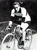 A man on a bicycle.