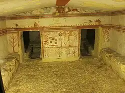 Tomb of the Bulls, back wall of main chamber. The main scene probably represents the ambush of Troilus