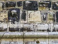 Reliefs of bust of Saint and human face with flower and date MCCLII (A.D. 1253) on the northern facade of the tower.