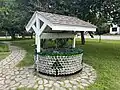 Non-functional water well made of glass bottles