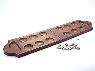 Mancala board and clay playing pieces