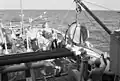USS Illusive lowers an acoustical device during an exercise.