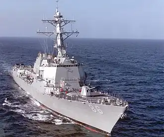 A grey ship on the ocean.