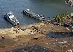 Indonesian Navy landing craft KRI Teluk Banten (516) and KRI Teluk Langsa (501) and a US Navy Seahawk helicopter in Calang